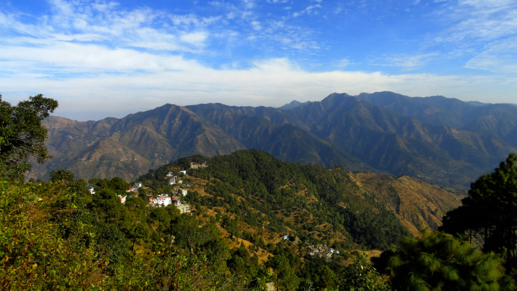 Scenic mountain view of Lansdowne with clouds floating above green valleys, captured from a hilltop.