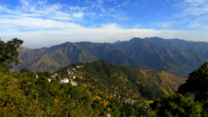 Scenic mountain view of Lansdowne with clouds floating above green valleys, captured from a hilltop.